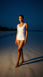 Woman wearing seamless white slimming body shaper tank top on the beach, showcasing tummy control shapewear with smooth fit and sculpting design